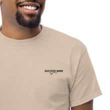 Load image into Gallery viewer, Close up of a Man wearing a SUCCESS WIRE sand color t-shirt with SUCCESS WIRE Logo on a white background