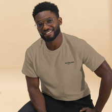 Load image into Gallery viewer, Man wearing a SUCCESS WIRE Brown Savana color t-shirt with SUCCESS WIRE logo on a beige background
