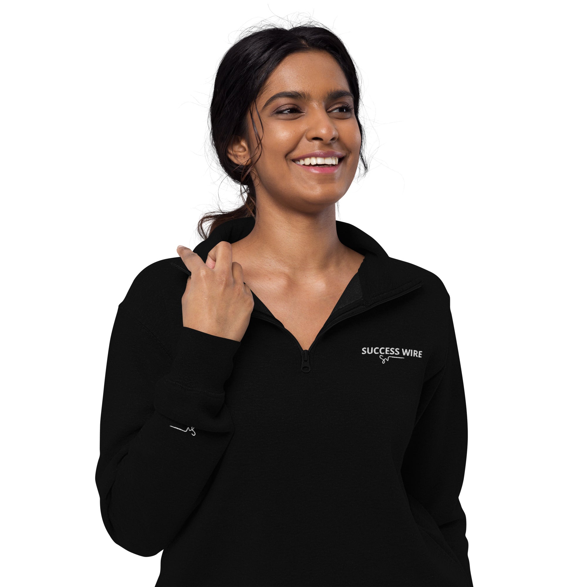 Woman wearing a black quarter zip pullover with 'SUCCESS WIRE' logo on a white background