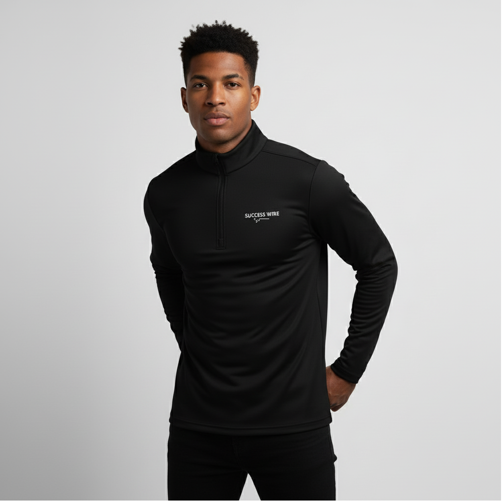 Man wearing a SUCCESS WIRE black quarter zip pullover with SUCCESS WIRE logo on a gray background