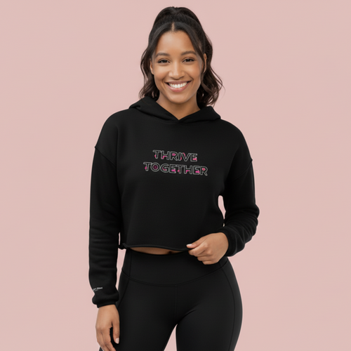 Woman wearing a black SUCCESS WIRE hoodie with 'Thrive Together' graphic text 