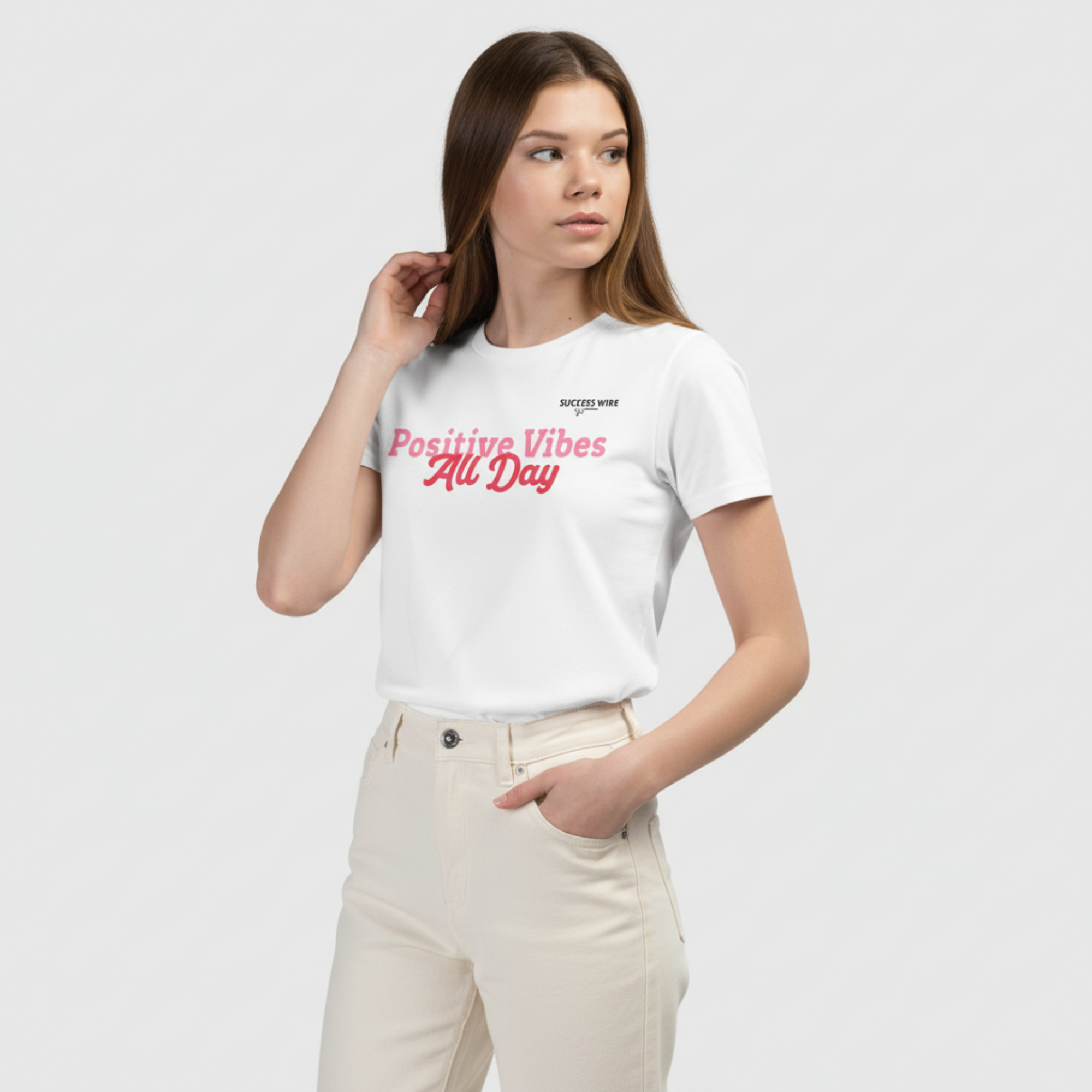 Girl wearing a white t-shirt with 'Positive Vibes All Day' text on a plain background